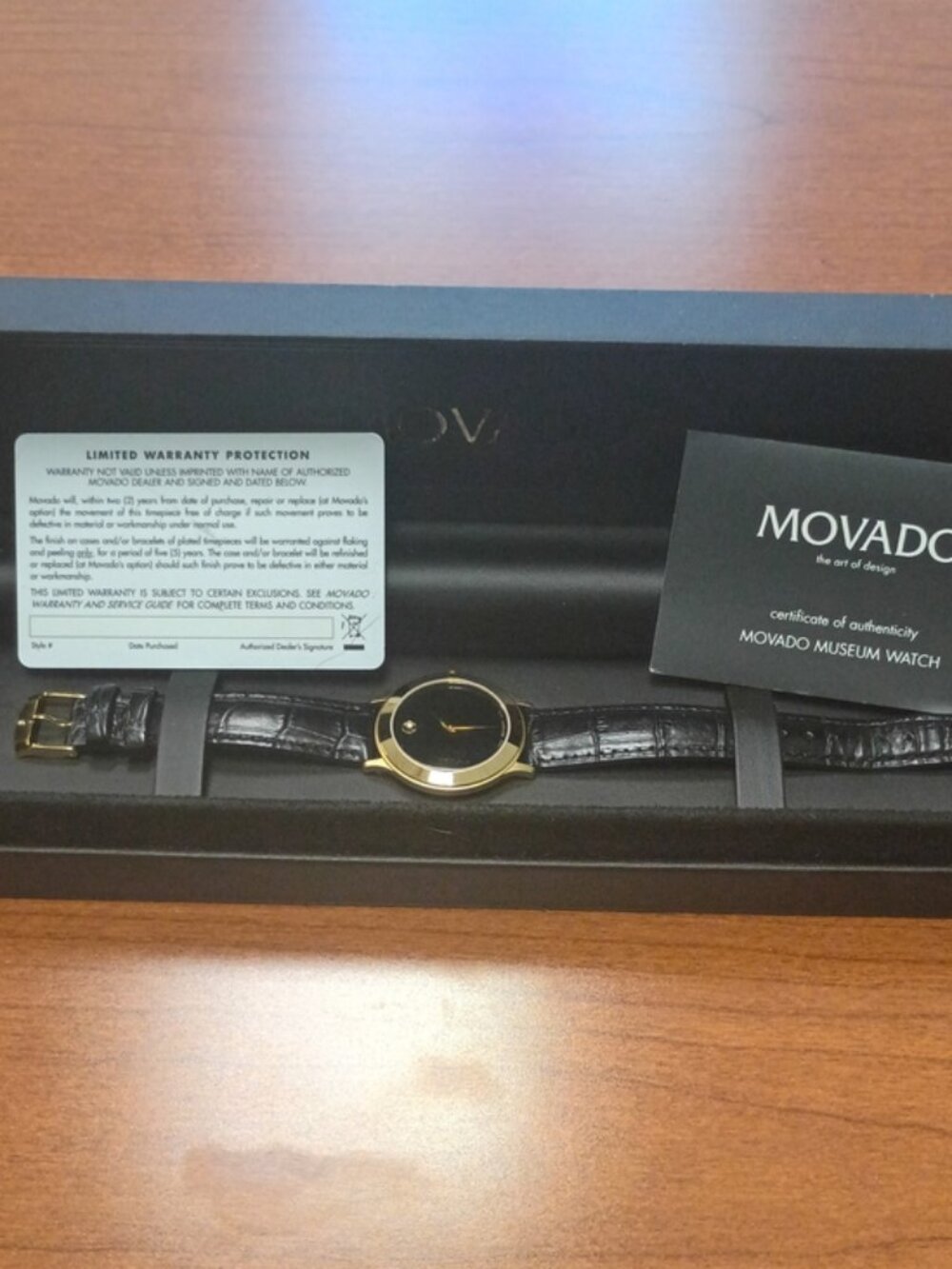 Movado Gold Tone Case with Black Dial and Black Leather Strap